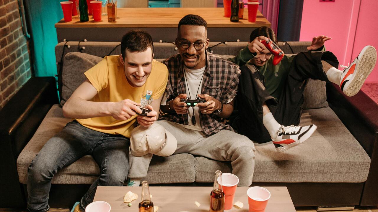 Friends playing with controllers on a couch
